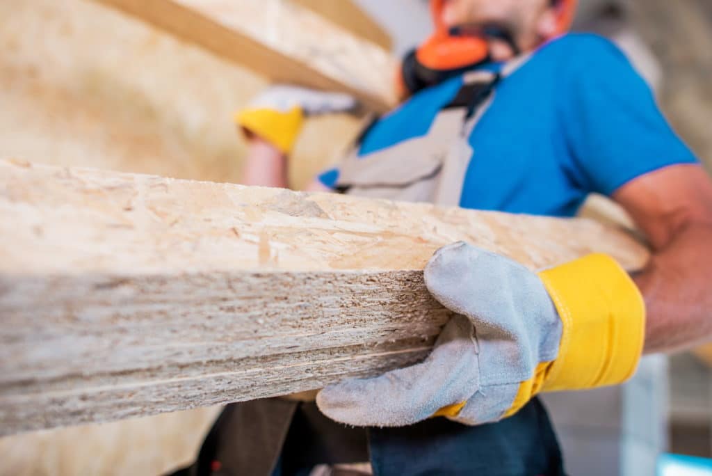 Worker with Wooden Materials in Hands. Closeup Photo.